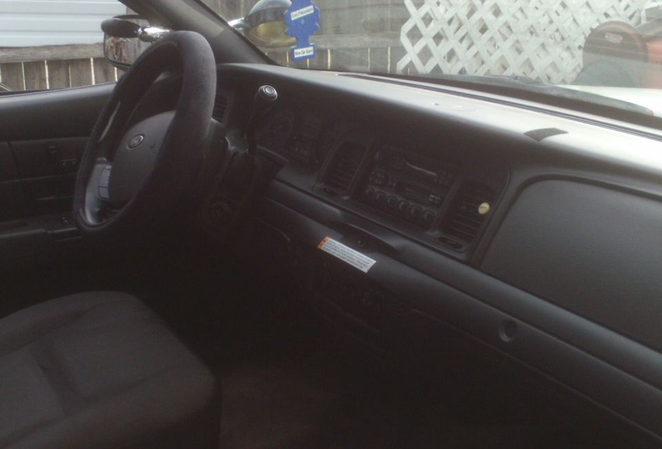 Interior dashboard of a 2006 Ford Crown Victoria, showing the steering wheel and center console