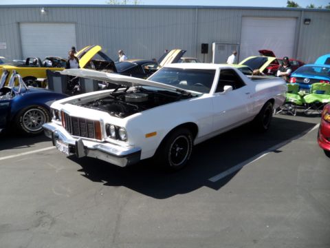 1973 Ford Ranchero - A white 1973 Ford Ranchero is displayed with its hood open at a car show.