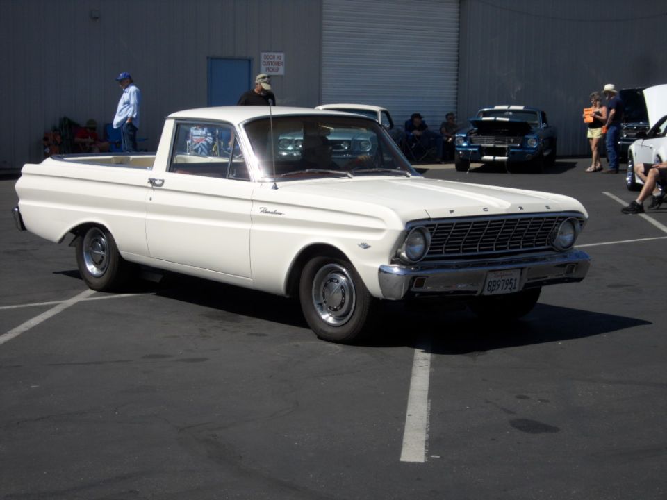white pickup truck with a bed, parked in a lot