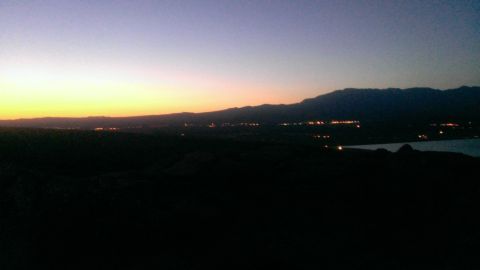1994 Ford Bronco - Distant lights twinkle in a valley at sunset, with mountains in the background.