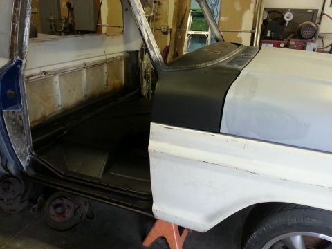 1967 Ford F-100 - The interior of a 1967 Ford F-100 truck is shown, with the driver's side door open and the front fender primed.