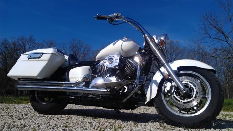 1995 Ford F-150 - A white motorcycle with saddlebags is parked outdoors on a gravel surface.