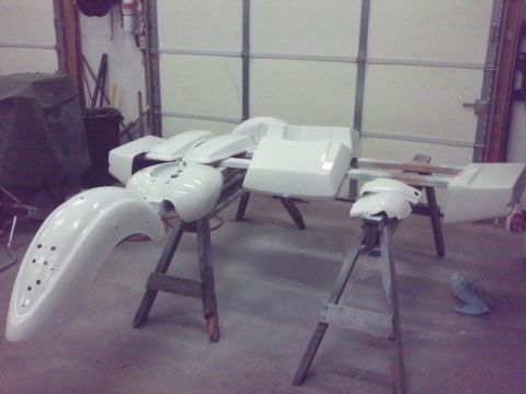 1995 Ford F-150 - Various motorcycle body parts are laid out on sawhorses, ready for painting.