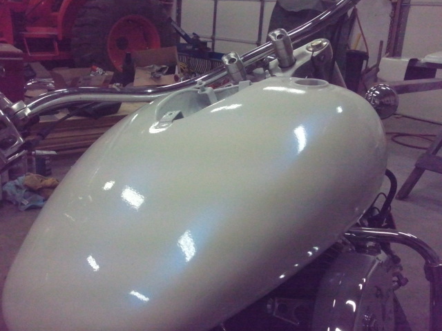 White motorcycle gas tank with chrome handlebars