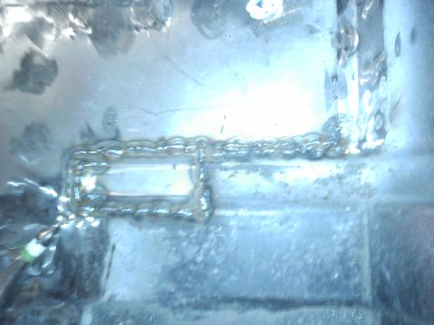1978 Ford Bronco - This image shows a section of a metal frame with fresh welds and a small wire attached.
