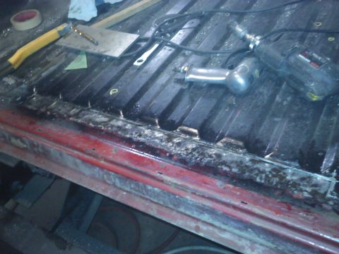 1978 Ford Bronco - Tools are laid out in the bed of a red truck, suggesting ongoing work.