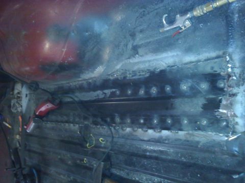 1978 Ford Bronco - Vehicle interior undergoing repair work on the floor pan, with welding visible.