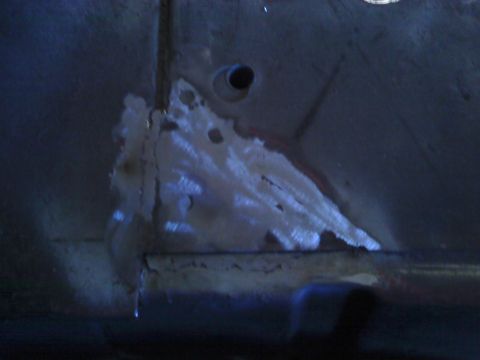 1978 Ford Bronco - Close-up view of a heavily rusted metal panel, showing signs of wear and damage.