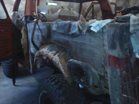 1978 Ford Bronco - This vehicle appears to be a Ford Bronco in a state of disassembly and repair, showing significant rust on the wheel well.