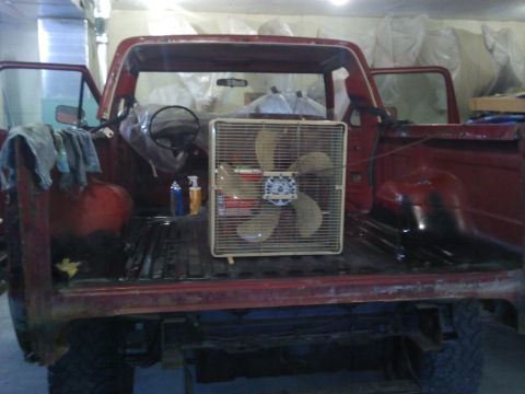 1978 Ford Bronco - Interior view of a red 1978 Ford Bronco with a box fan placed in the cargo area.
