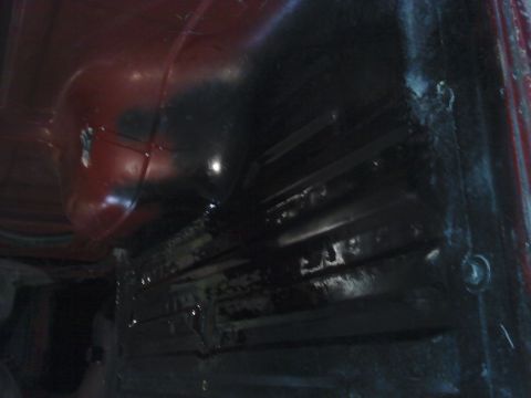 1978 Ford Bronco - The interior floor of a vehicle shows structural details and a wheel well, with a watermark at the bottom right.