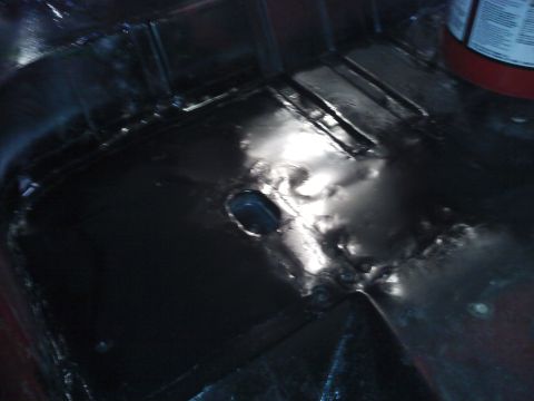 1978 Ford Bronco - The interior floor pan shows evidence of rust repair and a central drain hole.