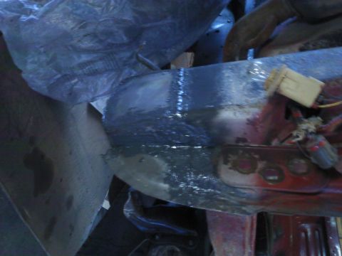 1978 Ford Bronco - Close-up of a vehicle frame undergoing repair, showing primer and welding.