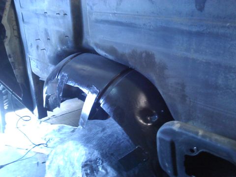 1978 Ford Bronco - Detail of the wheel well area, showing exposed metal and repair work.