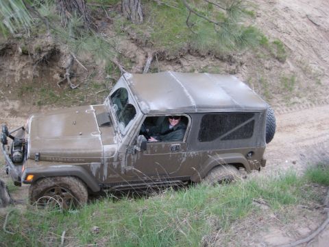 2005 Jeep Wrangler - A 2005 Jeep Wrangler navigates a muddy off-road trail.