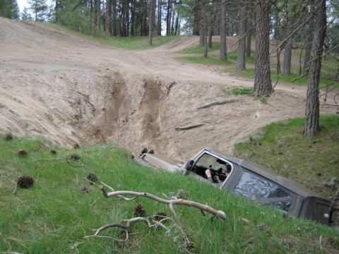 2005 Jeep Wrangler - A 2005 Jeep Wrangler is stuck in a steep, sandy ditch off-road.