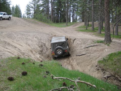 2005 Jeep Wrangler - Off-roading scene with a Jeep Wrangler navigating a challenging dirt path.