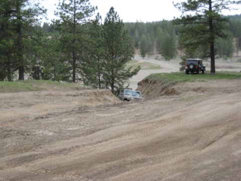 2005 Jeep Wrangler - Two Jeep Wranglers are seen in an off-road area, with one vehicle partially stuck in a ditch.