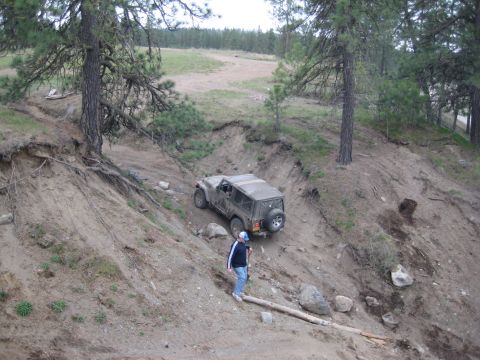 2005 Jeep Wrangler - Jeep Wrangler tackling an off-road trail on a sunny day.