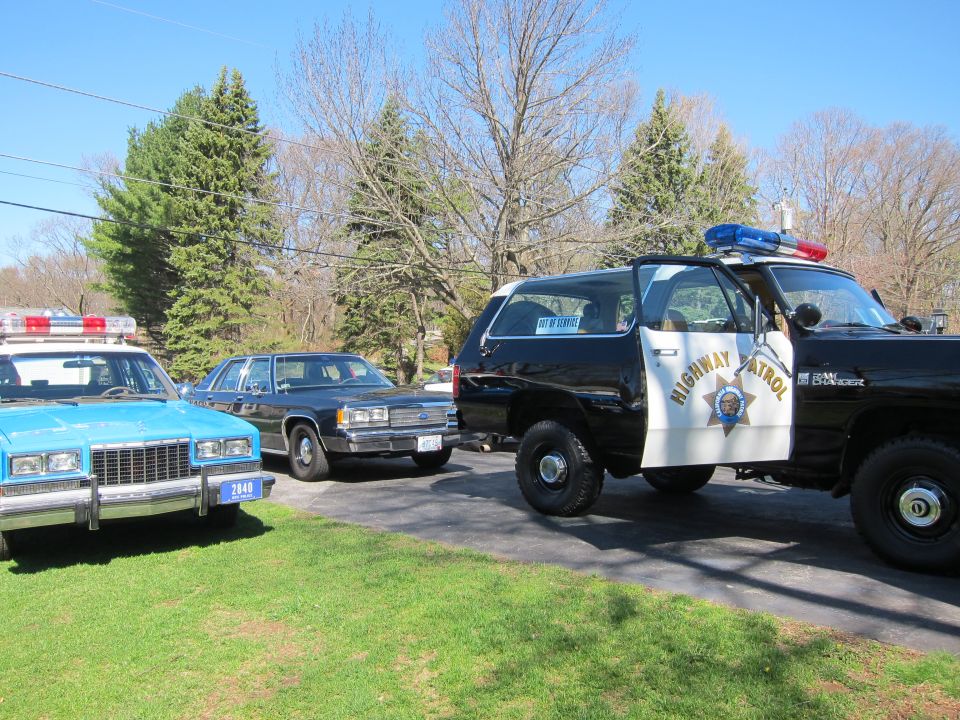 1991 Ford Crown Victoria LTD police car parked next to two other police vehicles