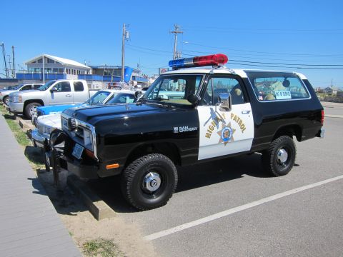 1991 Ford LTD Crown Victoria - This Dodge Ramcharger is marked as 'High Patrol' and 'Ramcharger' on the side, with a light bar on the roof.