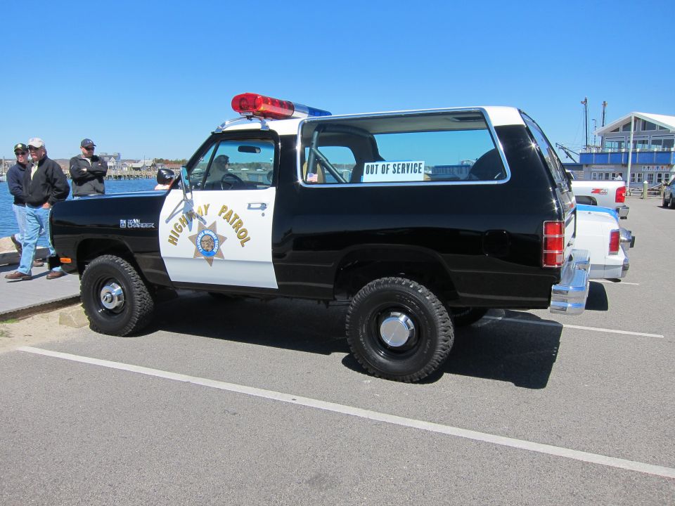 Black and white Dodge Ramcharger police SUV with "HIGHWAY PATROL" text and "OUT OF SERVICE" sign