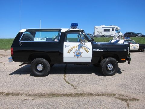 1991 Ford LTD Crown Victoria - Side view of a Dodge Ramcharger marked as Highway Patrol, with another patrol car in the background.
