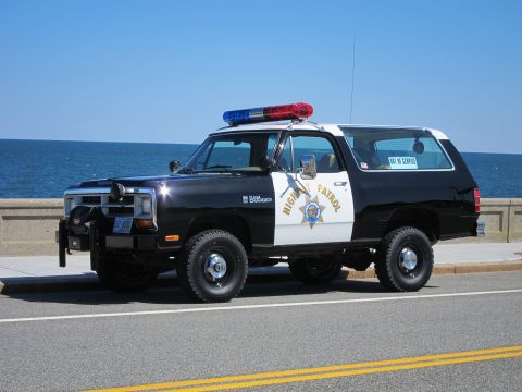 1991 Ford LTD Crown Victoria - This Dodge Ramcharger police vehicle is parked near the ocean, displaying 'HIGHWAY PATROL' on its side.