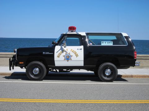 1991 Ford LTD Crown Victoria - This black and white police SUV, marked 'HIGHWAY PATROL', is seen parked by the water with an 'OUT OF SERVICE' sticker on the rear window.