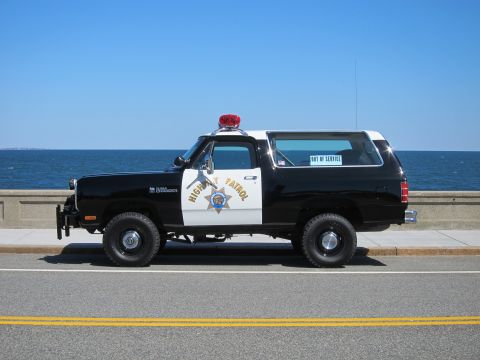 1991 Ford LTD Crown Victoria - This Dodge Ramcharger police vehicle is parked by the ocean with "OUT OF SERVICE" sticker on the rear window.