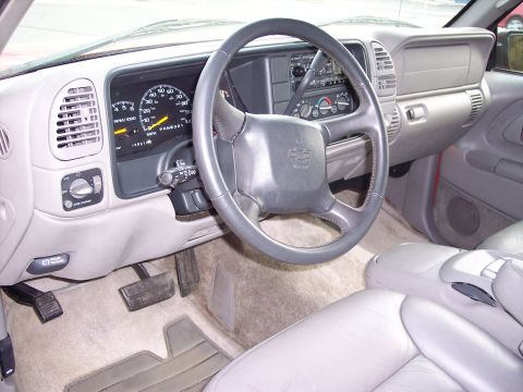 1999 Chevrolet Suburban - Interior view of a 1999 Chevrolet Suburban, showing the dashboard, steering wheel, and seating.