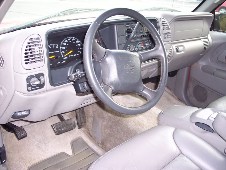 1999 Chevrolet Suburban interior with dashboard, steering wheel, and seats