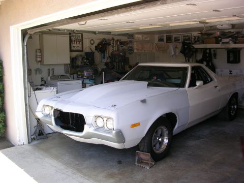 1972 Ford Ranchero - A 1972 Ford Ranchero is undergoing restoration in a garage, showing its front end and driver's side.