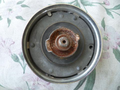 1973 Ford Ranchero - This is a close-up view of the underside of a gas cap, showing signs of rust.