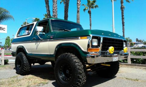 1994 Ford Bronco - This lifted Ford Bronco features a two-tone paint scheme and prominent off-road tires.
