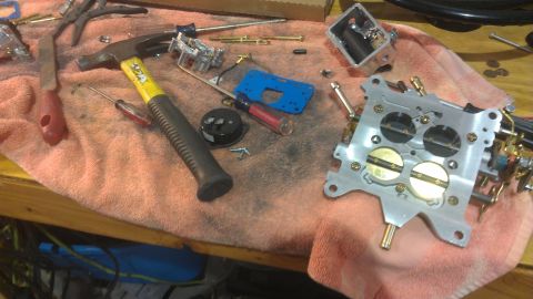 1980 Pontiac Trans Am - Carburetor parts and tools are laid out on a towel, suggesting a repair or rebuild in progress.