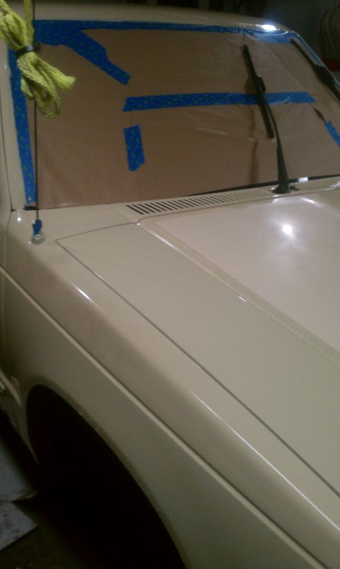 1991 Chevrolet S10 - Cream colored truck hood and fender with windshield taped off for painting.