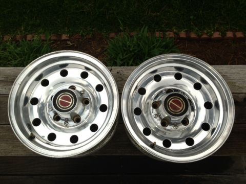 1986 Ford Bronco - Pair of polished aluminum wheels with Ford center caps, likely from a 1986 Bronco.