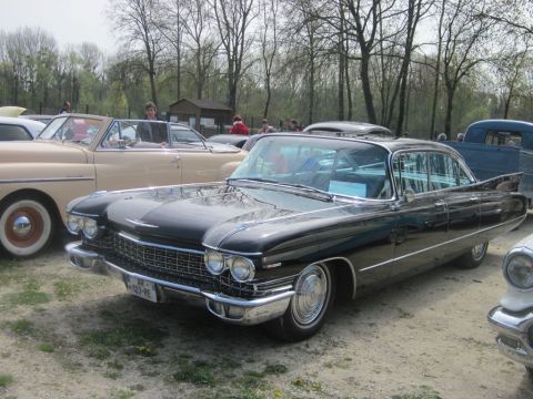 1991 Ford LTD Crown Victoria - A black 1959 Cadillac Sedan de Ville is parked at an outdoor event with other classic cars.
