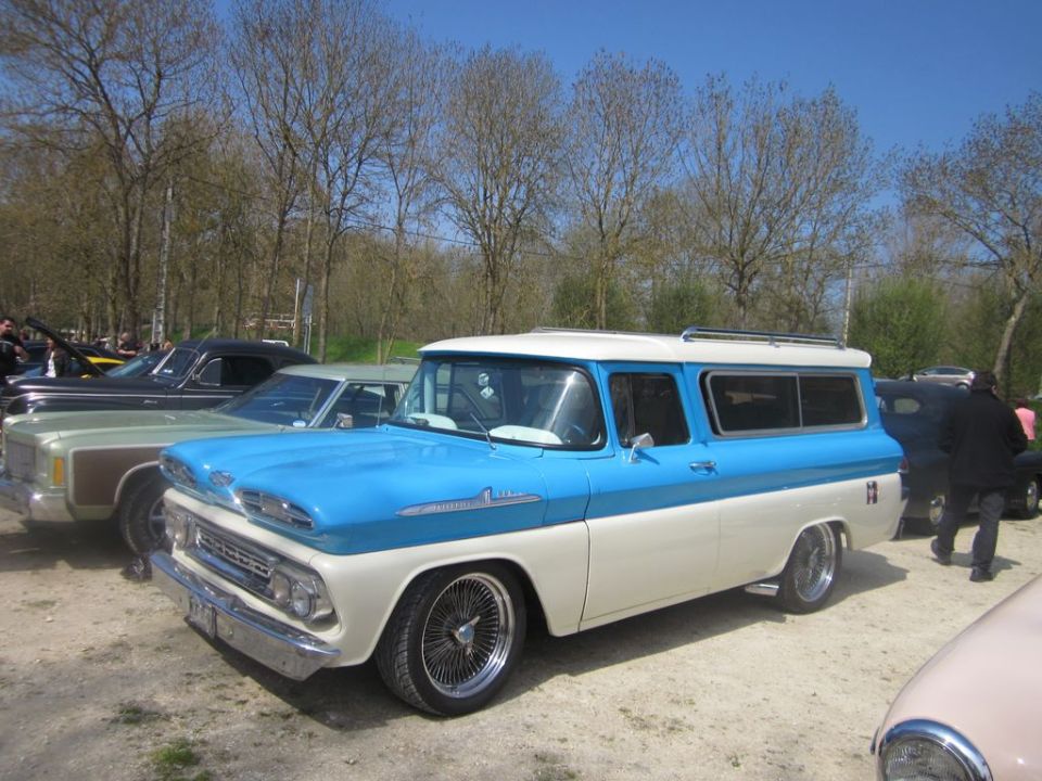 1959 Chevrolet Suburban two-tone blue and white with chrome wheels parked outdoors