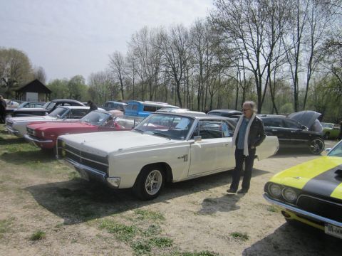 1991 Ford LTD Crown Victoria - A gathering of classic cars on a sunny day, with a white Dodge Coronet as the prominent vehicle.