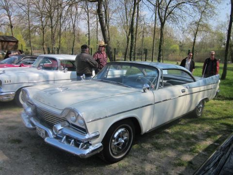1991 Ford LTD Crown Victoria - A classic white and blue coupe with a distinctive grille and chrome accents is seen at an outdoor gathering.