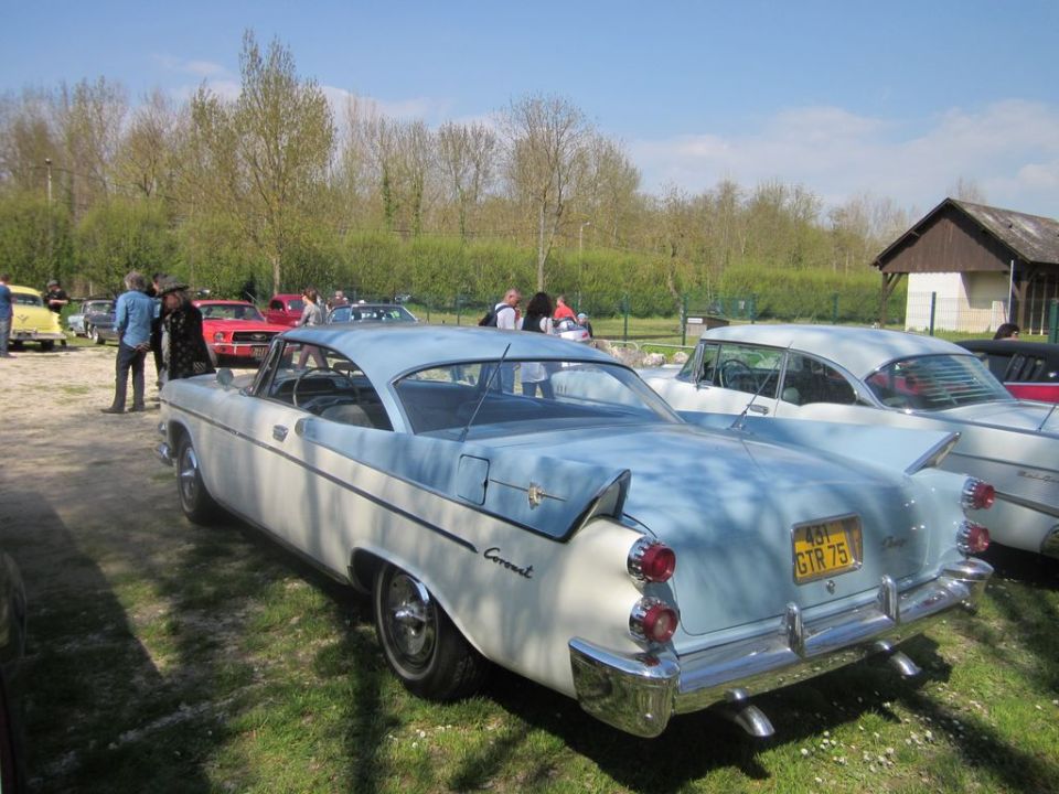 Rear view of a light blue and white coupe with a yellow license plate reading GTR 75