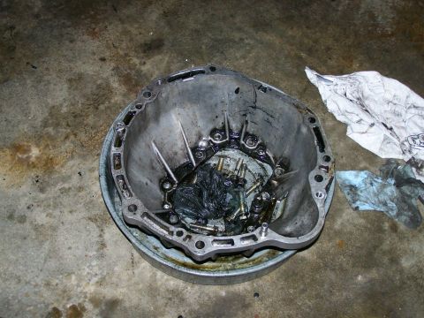 1988 Suzuki Samurai - Transmission bell housing removed from vehicle, showing internal components and grease.