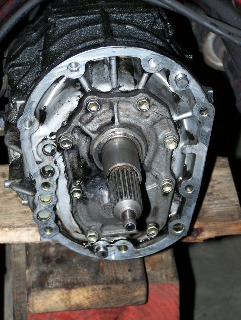 1988 Suzuki Samurai - This image shows a close-up view of a vehicle's transmission housing, resting on wooden blocks.