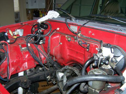 1988 Suzuki Samurai - Vehicle engine bay with brake booster and master cylinder visible, undergoing work.