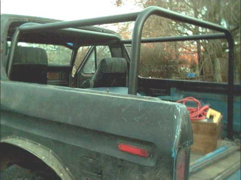 1978 Ford Bronco - Interior view of a 1978 Ford Bronco, showing the installed roll cage and rear seating.