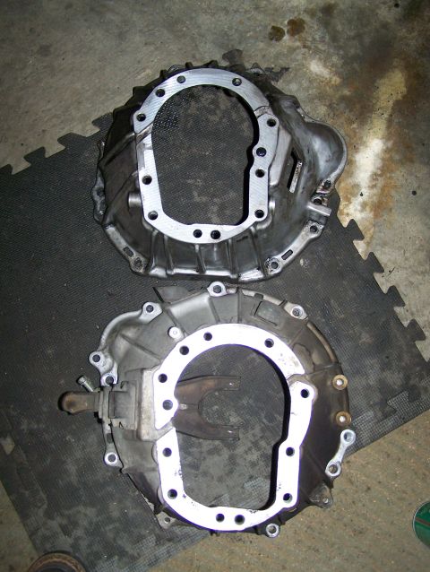 1988 Suzuki Samurai - Two transmission bell housings are shown, one above the other, on a dark mat.