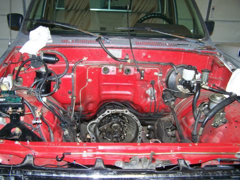1988 Suzuki Samurai - The engine bay shows a transmission removed, revealing the firewall and brake system.