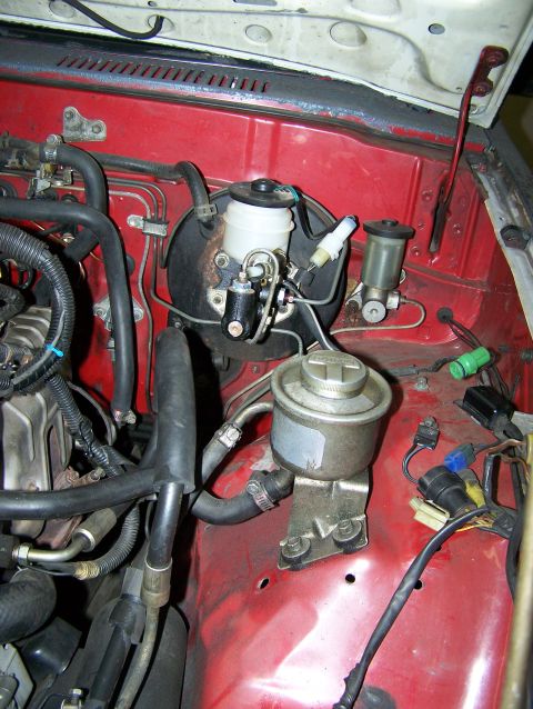 1988 Suzuki Samurai - Engine bay components including brake booster, master cylinder, and power steering reservoir are visible.